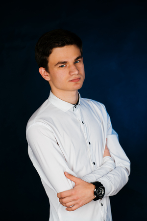 young brunette guy in a white shirtの写真素材