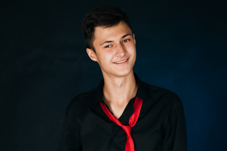 Portrait young guy on a dark studioの写真素材