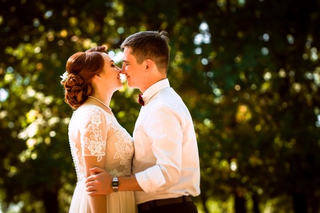 The bride and groom in the background of park treesの写真素材