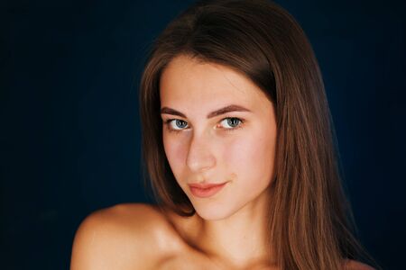 Portrait beautiful girl on a dark studio backgroundの写真素材