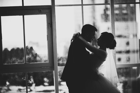 black white photo bride and groom on background clear windowsの写真素材