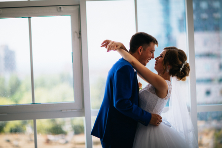 Bride and groom on background clear windowsの写真素材