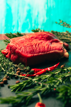 raw beef meat with spices on slate stone kitchen boardの写真素材