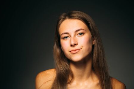 Portrait beautiful girl on a dark studio backgroundの写真素材