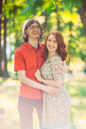 Beautiful young couple on the park backgroundの写真素材