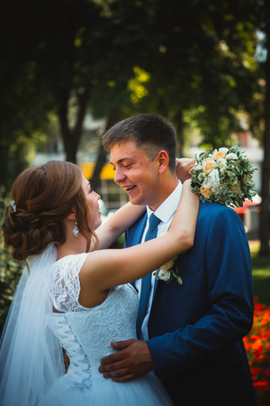 couple groom and bride hugging and kissing on nature park backgroundの写真素材