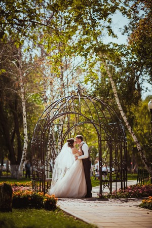 The bride and groom in the park archの写真素材