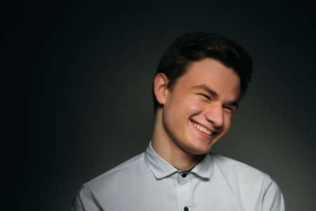 young brunette guy in a white shirtの写真素材
