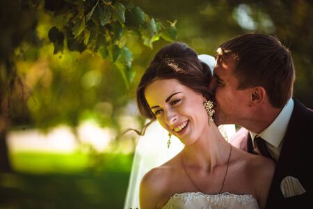 young couple groom and the bride on the park background.の写真素材
