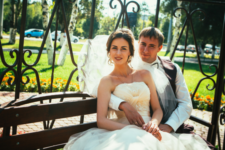 The bride and groom in the gazebo in the parkの写真素材