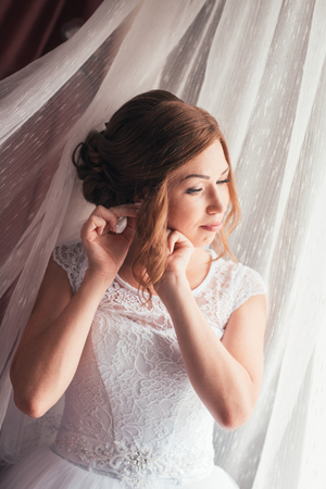Portrait of a young bride on a light backgroundの写真素材