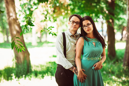 Beautiful young couple on the park backgroundの写真素材