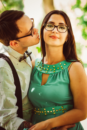 Beautiful young couple on the park backgroundの写真素材