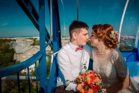 A bride and a groom in the Ferris wheelの写真素材