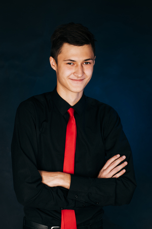 Portrait young guy on a dark studioの写真素材