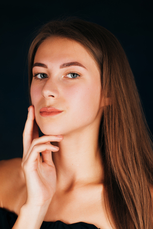 Portrait beautiful girl on a dark studio backgroundの写真素材
