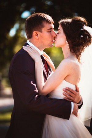 young couple groom and the bride on the park backgroundの写真素材