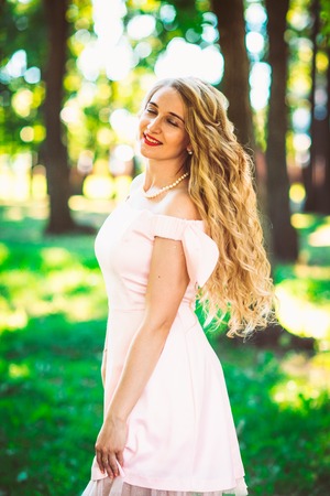 beautiful girl blonde on nature backgroundの写真素材