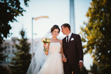 young couple groom and the bride on the park background.の写真素材