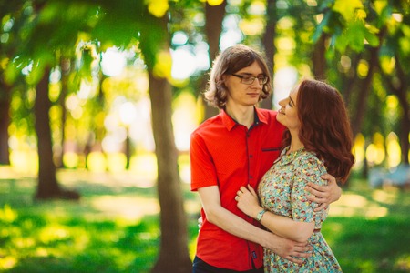 Beautiful young couple on the park backgroundの写真素材