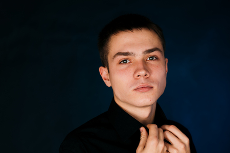 young guy on a dark studio backgroundの写真素材