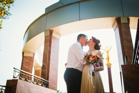 bride and groom on the background of the buildingの写真素材