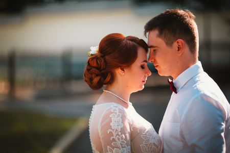 groom and the bride against the trees of the parkの写真素材