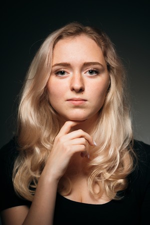 young girl blonde on a dark backgroundの写真素材