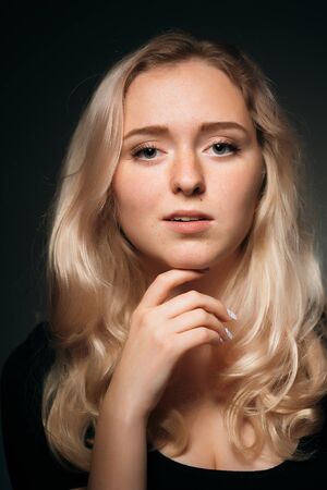 young girl blonde on a dark backgroundの写真素材