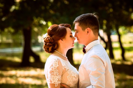 The bride and groom in the background of park treesの写真素材