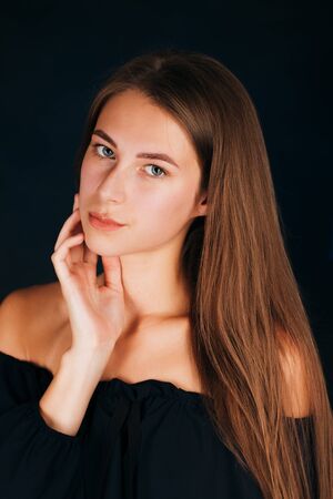 Portrait beautiful girl on a dark studio backgroundの写真素材
