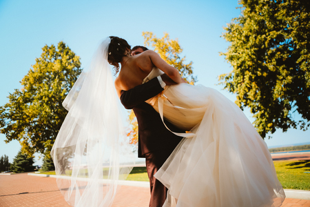 young couple groom and the bride on the park background.の写真素材