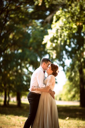 The bride and groom in the background of park treesの写真素材