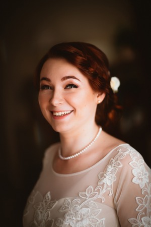 Portrait of a beautiful young bride near the windowの写真素材