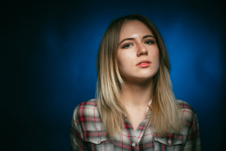 portrait smiling girl on blue background in studioの写真素材