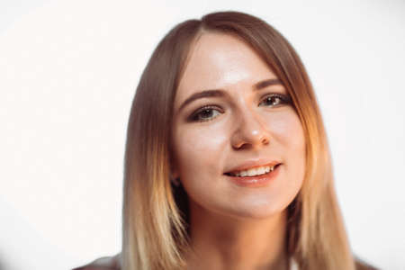 portrait smiling girl on white background in studio