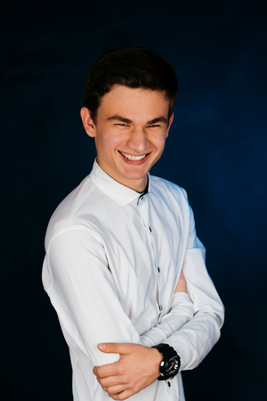 young brunette guy in a white shirtの写真素材