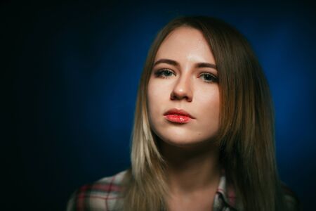 portrait smiling girl on blue background in studioの写真素材