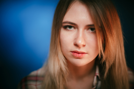 portrait smiling girl on blue background in studioの写真素材