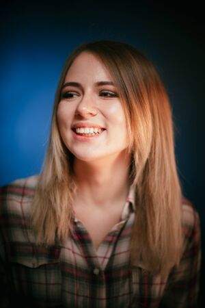 portrait smiling girl on blue background in studioの写真素材