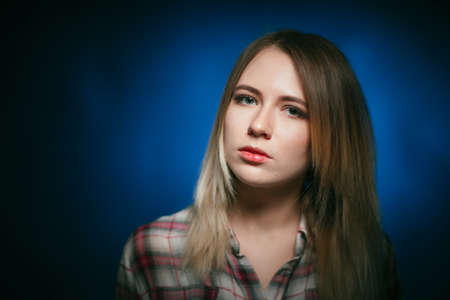 portrait smiling girl on blue background in studioの写真素材