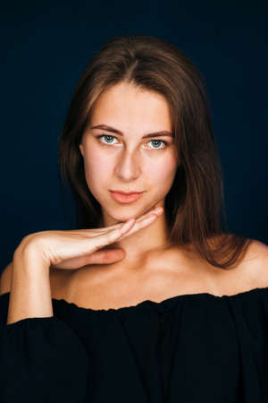 Portrait beautiful girl on a dark studio backgroundの写真素材