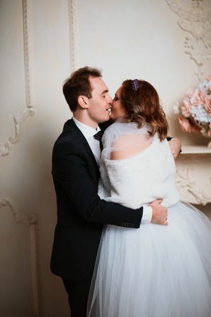 young bride and groom couple in a bright studio photoの写真素材