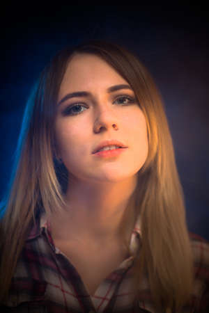 portrait smiling girl on blue background in studioの写真素材