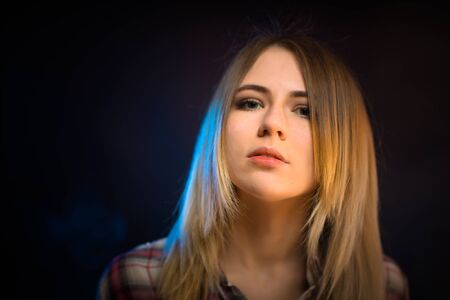 portrait smiling girl on blue background in studioの写真素材