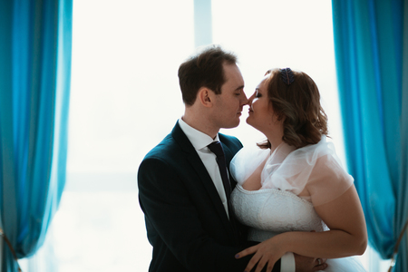 young bride and groom couple in a bright studio photoの写真素材