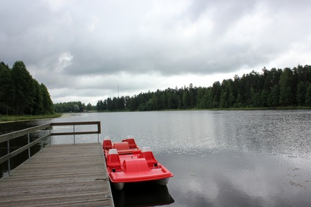 Beautiful calm lake landscape with a catamaranの写真素材