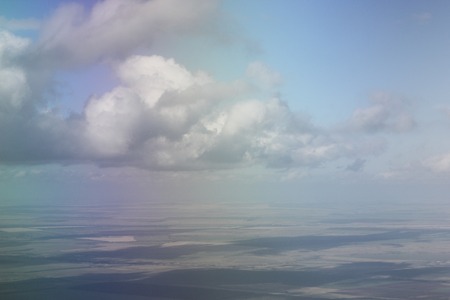 White clouds in the sky are photographed at the height of the flight of the aircraft