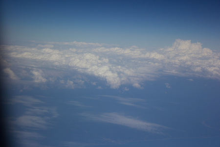 White clouds in the sky are photographed at the height of the flight of the aircraftの写真素材