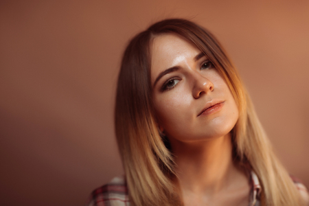 portrait smiling girl on orange background in studio.の写真素材
